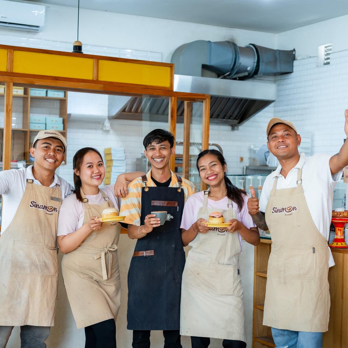 Happy customers enjoying Sinamon cinnamon rolls